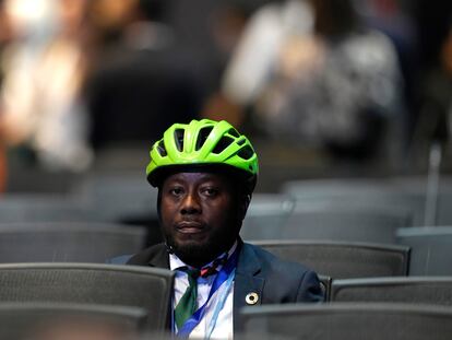 Ivorian activist Andy Costa, wearing his helmet and tie, on Monday at the opening of COP27 in Sharm el Sheikh.