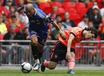 Lionel Messi (derecha) disputa un balón con Wael Gomaa.