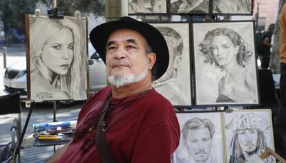 Galo, ante a algunos de sus retratos en la Rambla.