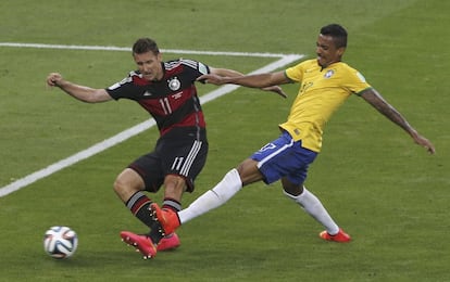 O atacante alemão Miroslav Klose chuta diante do meia Luiz Gustavo, na jogada do segundo gol para a equipe alemã.