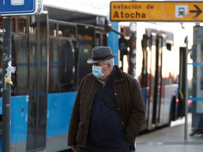 A man wears a mask outside Atocha train station in Madrid on Monday.