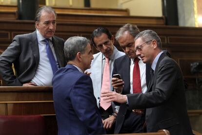 El ministro de Justicia, Alberto Ruiz-Gallardón, junto a otros diputados, en el Hemiciclo.