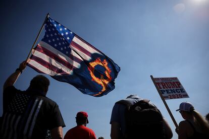 A supporter of President Donald Trump holds a flag with a reference to the QAnon conspiracy theory at a rally in September.