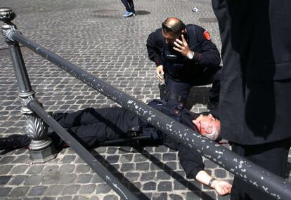 Un carabinieri yace en el suelo después de recibir un tiro en el cuello por un hombre vestido de chaqueta y corbata, en la puerta de palacio Chigi.