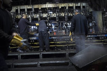 In this Wednesday, Jan. 27, 2016 photo, glass bottles move on the line of production at the Phoenicia Glass Works Ltd. factory in the southern Israeli town of Yeruham. Phoenicia Glass Works Ltd. produces a million bottles and containers a day for beverage giants Coca Cola, Pepsi, and Heineken, as well as Israeli wineries and olive oil companies. Every day, about 300,000 bottles come out of the ovens with defects. (AP Photo/Oded Balilty)