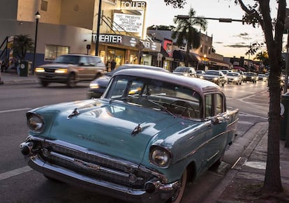 A vintage Chevrolet parked in front of the art nouveau Tower Theater movie house.