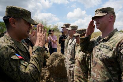 Philippine Army Artillery Regiment Commander Anthony Coronel returns a salute from a U.S. soldier during a joint military drill in northern Philippines, on March 31, 2023.