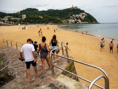 Bañistas se dirigen a la playa de Ondarreta de San Sebastián (Gipuzkoa) durante este miércoles de calor.