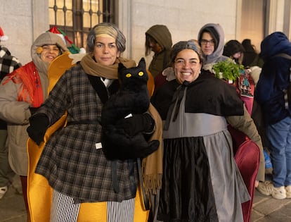 Dos personas disfrazadas sin reparos a la mala suerte atribuida a los gatos negros.