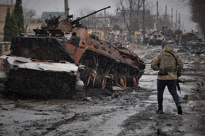 Remains of bombed combat vehicles on a street in Bucha.