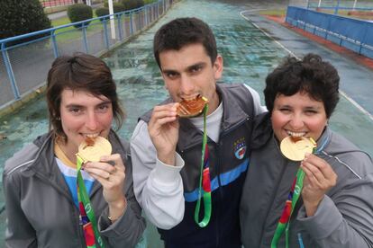 Romina, Nicol&aacute;s y Victoria muestran las medallas ganadas en Polonia.