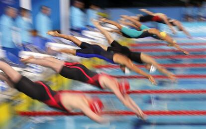 Las nadadoras se lanzan al agua en la semifinal de 100 metros mariposa femenino en el Aquatic Centre durante los Juegos de la Commonwealth, en Gold Coast (Australia), el 5 de abril de 2018.