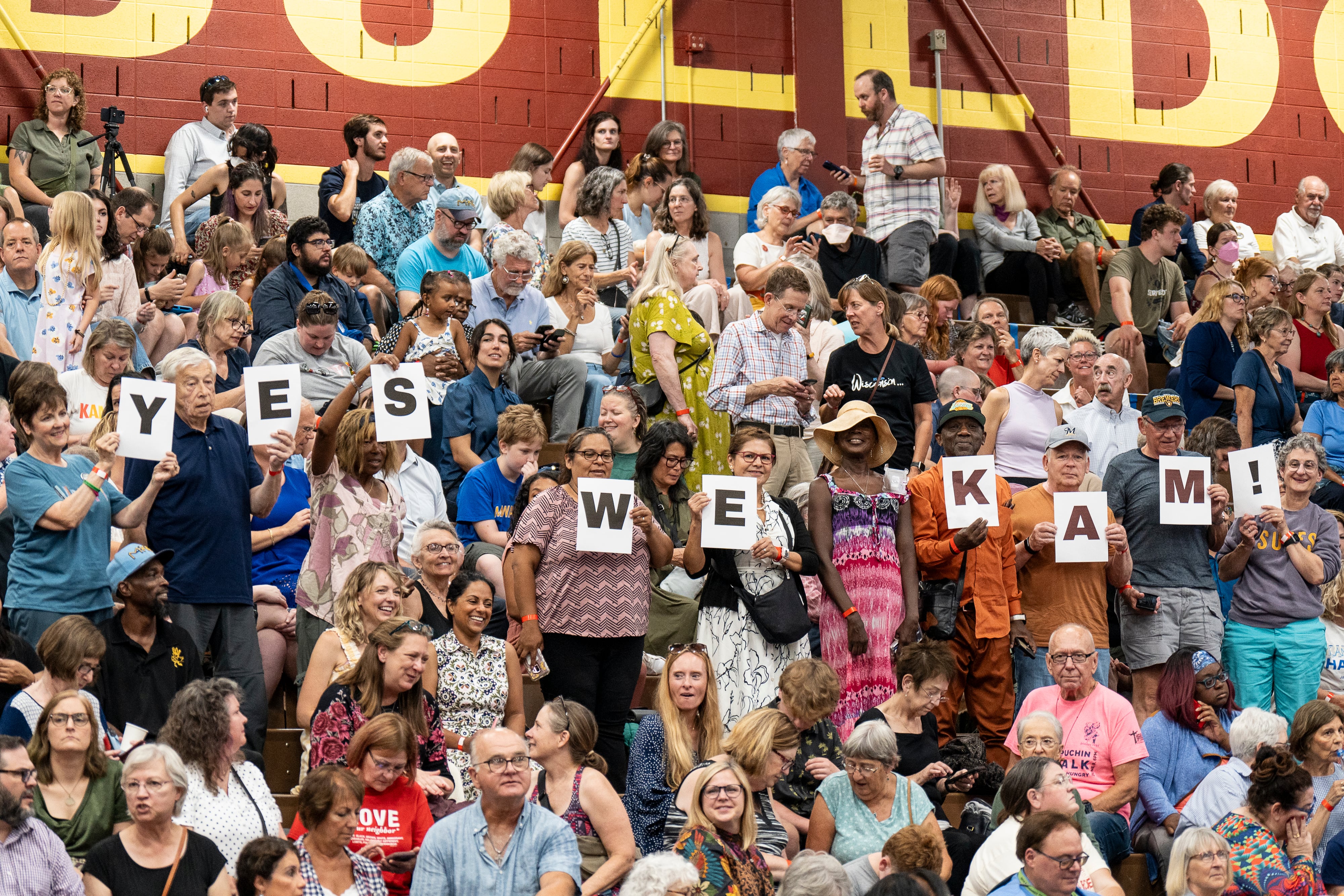 WEST ALLIS, WI - JULY 23: A group of attendees in the crowd hold up letters that spell out 