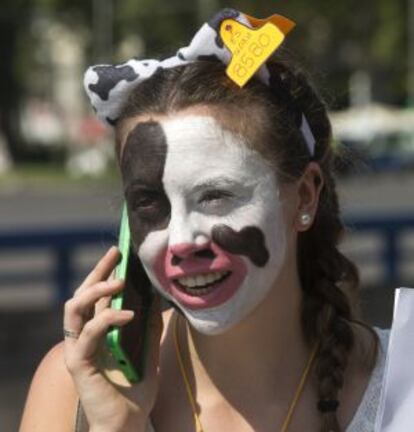 Una manifestante con la cara pintada de vaca a su llega a Madrid