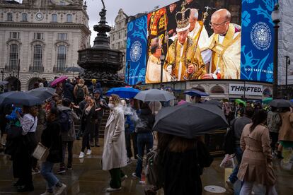 Varias personas pasaban el sábado junto a una pantalla gigante en el centro de Londres, que mostraba una imagen del rey Carlos III de Gran Bretaña durante la ceremonia de coronación en la Abadía de Westminster.