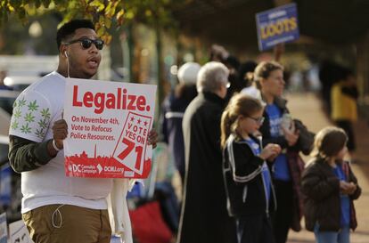 Un activista de DC Cannabis Campaign muestra un cartel en el que se pide la legalización de la marihuana a la entrada del colegio electoral Mercado Oriental en Washington.