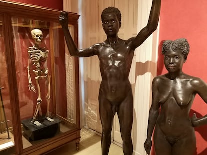 The skeleton of a Filipina woman at the National Museum of Anthropology in Madrid, next to two 19th-century statues of people from Equatorial Guinea. 