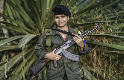 Manuela, a member of the Revolutionary Armed Forces of Colombia (FARC), poses for a picture at a camp in the Colombian mountains on February 18, 2016. Many of these women are willing to be reunited with the children they gave birth and then left under protection of relatives or farmers, whenever the peace agreement will put an end to the country's internal conflict.    AFP PHOTO / LUIS ACOSTA