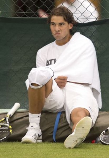 Spain&#039;s Rafael Nadal sits at the side of the court after a practice session on the eve of the start of the Wimbledon Championships.