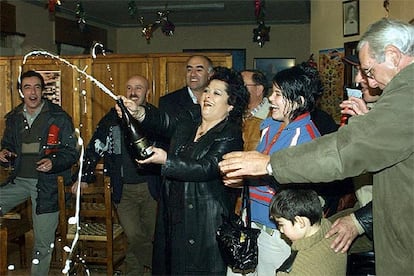 Algunos de los agraciados con el segundo premio del Sorteo Extraordinario de Lotería de <i>El Niño</i> celebran su suerte con cava en un bar de Cistierna (León), donde se ha vendido el número premiado. El alcalde de la localidad, Nicanor Sen, ha definido este golpe de la fortuna como un "balón de oxígeno" tras las dificultades vividas en los últimos años a causa del declive de la minería.