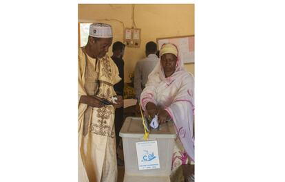 Un hombre vigila el voto de su una de sus mujeres, previamente ha votado otra. La poligamia está aceptada en Níger y es, además, recurrente, en un país de mayoría musulmana que no olvida la tradición animista.