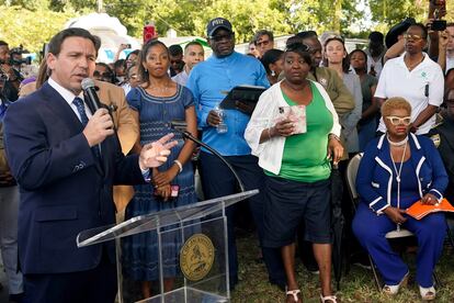 Florida Gov. Ron DeSantis, left, speaks at a prayer vigil for the victims of a mass shooting a day earlier, in Jacksonville, Florida, on Aug. 27, 2023.