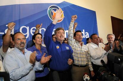 Francisco "Kiko" Vega (blue shirt) celebrates his victory with supporters.