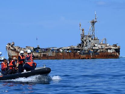 A Philippine Coast Guard boat carrying journalists passes the 'Sierra Madre' in the South China Sea on November 10.