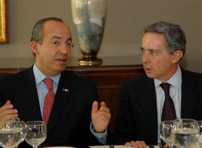 El presidente mexicano, Felipe Calderón, habla con su homólogo colombiano Álvaro Uribe durante un almuerzo en Medellín.