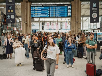 Travellers look at information screens at Paris' Gare du Nord.

