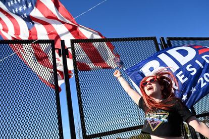 Una joven partidaria del candidato demócrata ondea una bandera para celebrar el triunfo de Biden en Wilmington (Delaware).