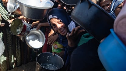 Un grupo de gazatíes desplazados hacen cola para recibir comida en Khan Yunis, en el sur de Gaza.
