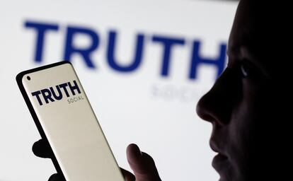 Una usuaria mira la pantalla de su móvil con el logo de 'The Truth social'