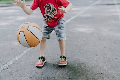 Un niño juega con su balón. 