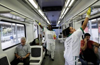 Duas mulheres desinfectam o vagão de um trem no Rio de Janeiro para combater o coronavírus.