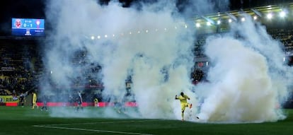 Villarreal' s forward Jonathan Pereira kicks the teargas cannister thrown onto the field during the match against Villarreal.
