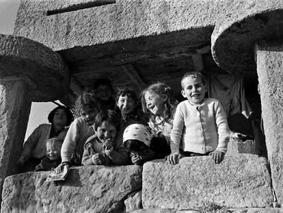 Niños fotografiados por Blanco Amor en los años 60 jugando bajo un hórreo de Louro, en el municipio coruñés de Muros.