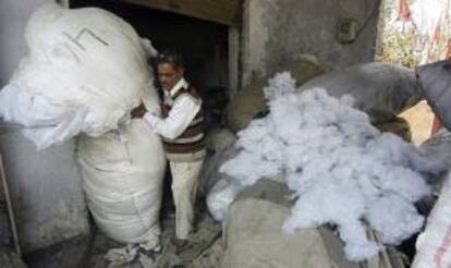 Un trabajador mete algodón en una bolsa en un taller en las afueras de Jammu, la capital invernal de la Cachemira bajo soberanía india. EFE/Archivo