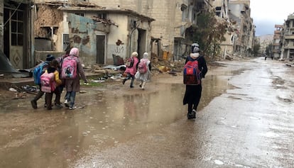 Niñas sirias caminan bajo la lluvia después de salir del colegio en Daraa. el pasado año.