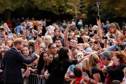 The Duke and Duchess of Sussex, Harry and Meghan, wave to the hundreds of people who gathered outside Windsor Castle. 