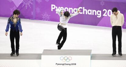 De izquierda a derecha, Shoma Uno de Japón (plata), Yuzuru Hanyu de Japón (oro) y Javier Fernández de España en el podio después de la prueba.