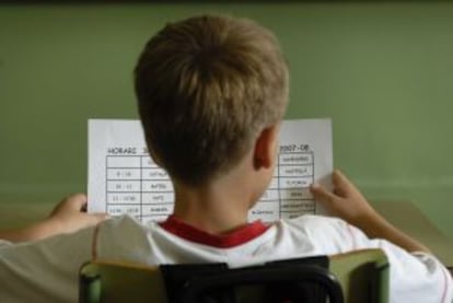 Un ni&ntilde;o revisa su horario escolar en Catalu&ntilde;a.