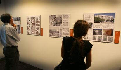 Dos visitants observen l'exposició sobre arquitectura valenciana recent.