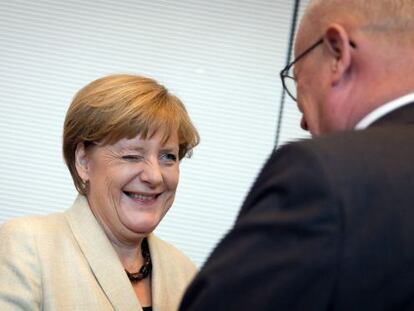 La canciller Angela Merkel sonríe al jefe del grupo parlamentario de la CDU, Volker Kauder, antes de la reunión de su grupo parlamentario.