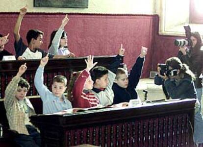 Los miembros de un grupo votan una propuesta en el pleno infantil de ayer en Sevilla.