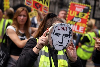 A person holds a tambourine with an image of London's Mayor Sadiq Khan, during a demonstration outside the Houses of Parliament on Aug. 29, 2023.