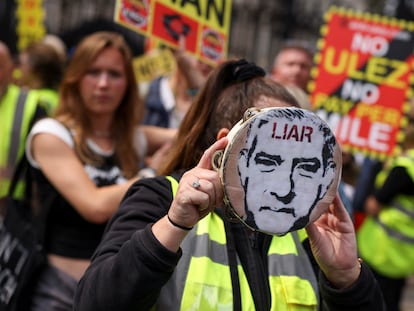 A person holds a tambourine with an image of London's Mayor Sadiq Khan, during a demonstration outside the Houses of Parliament on Aug. 29, 2023.