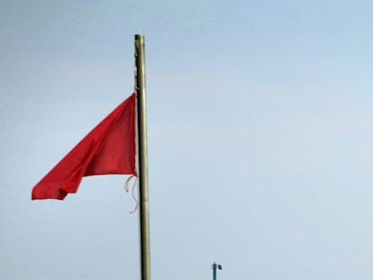 Bandera roja en una playa.