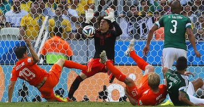 Ochoa detiene un disparo de Huntelaar durante un partido entre México y Holanda en el Mundial de 2014.