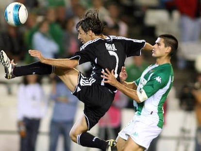 Raúl intenta controlar un balón ante Juanito, del Betis.